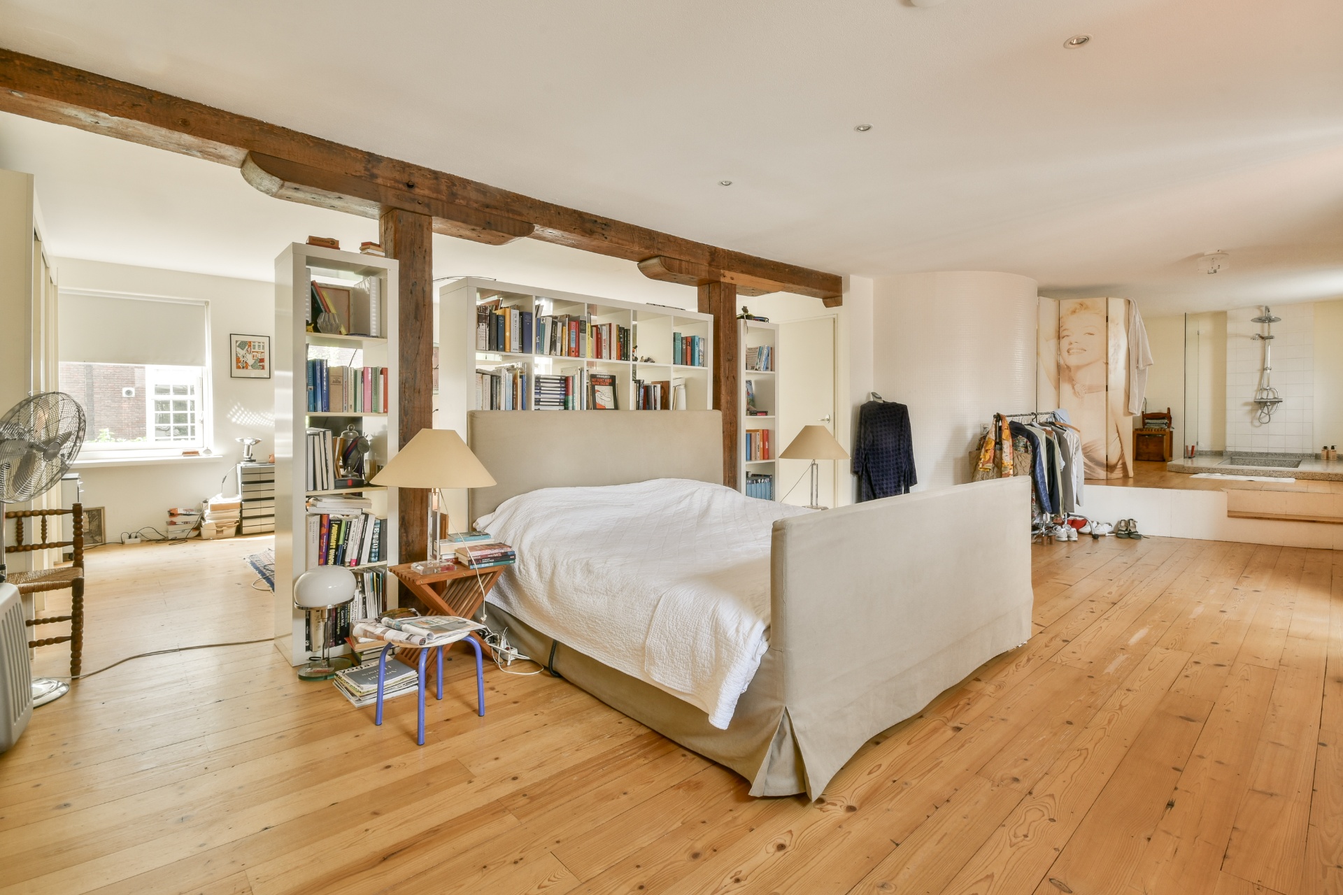 Charming loft bedroom with exposed wooden beams and built-in storage