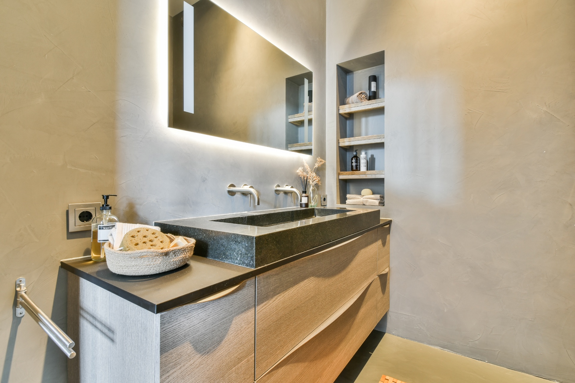 Sophisticated bathroom with floating vanity, LED mirror and built-in storage niches