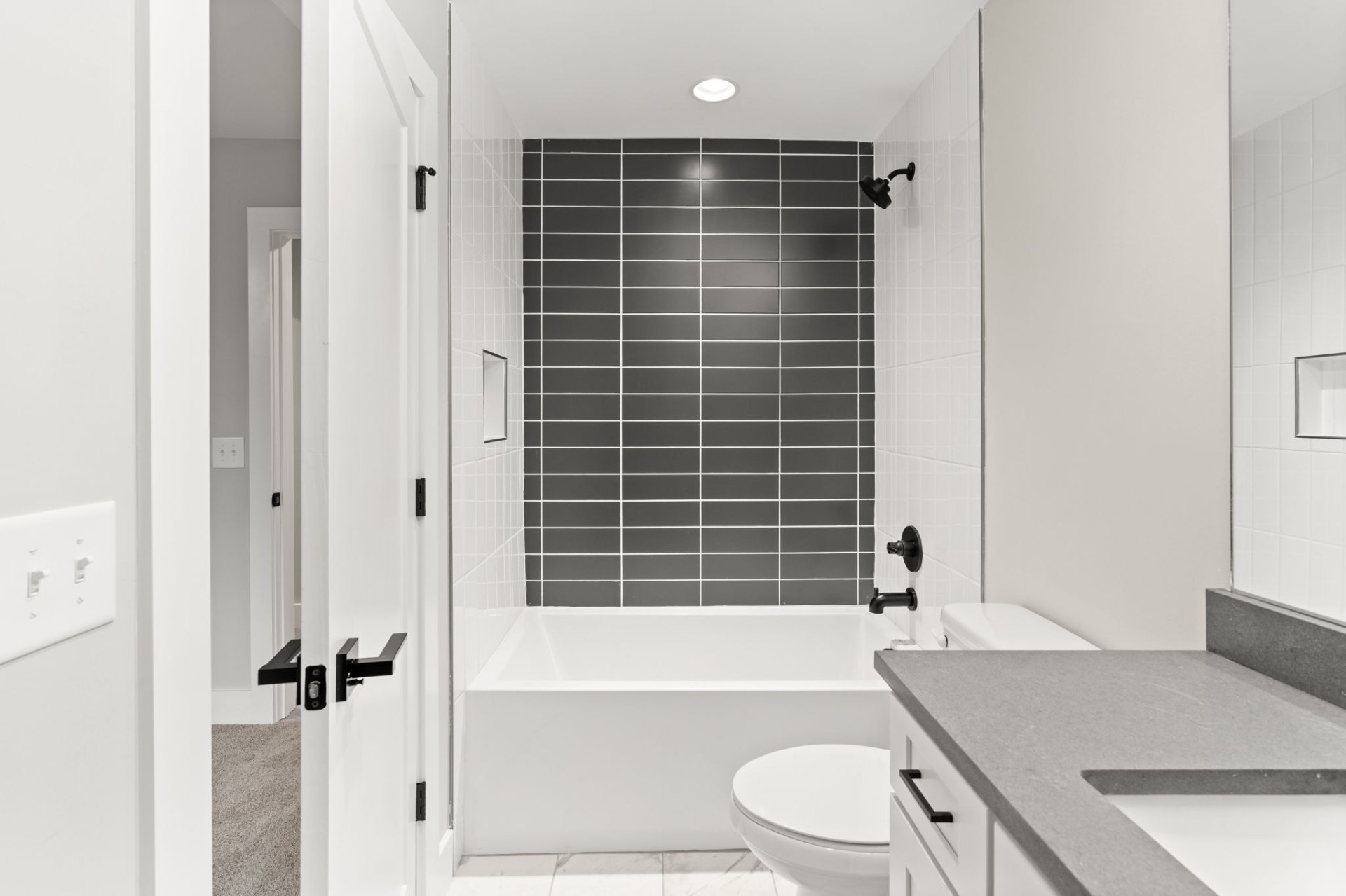 Elegant bathroom with gray subway tile shower, white vanity and spa-like ambiance