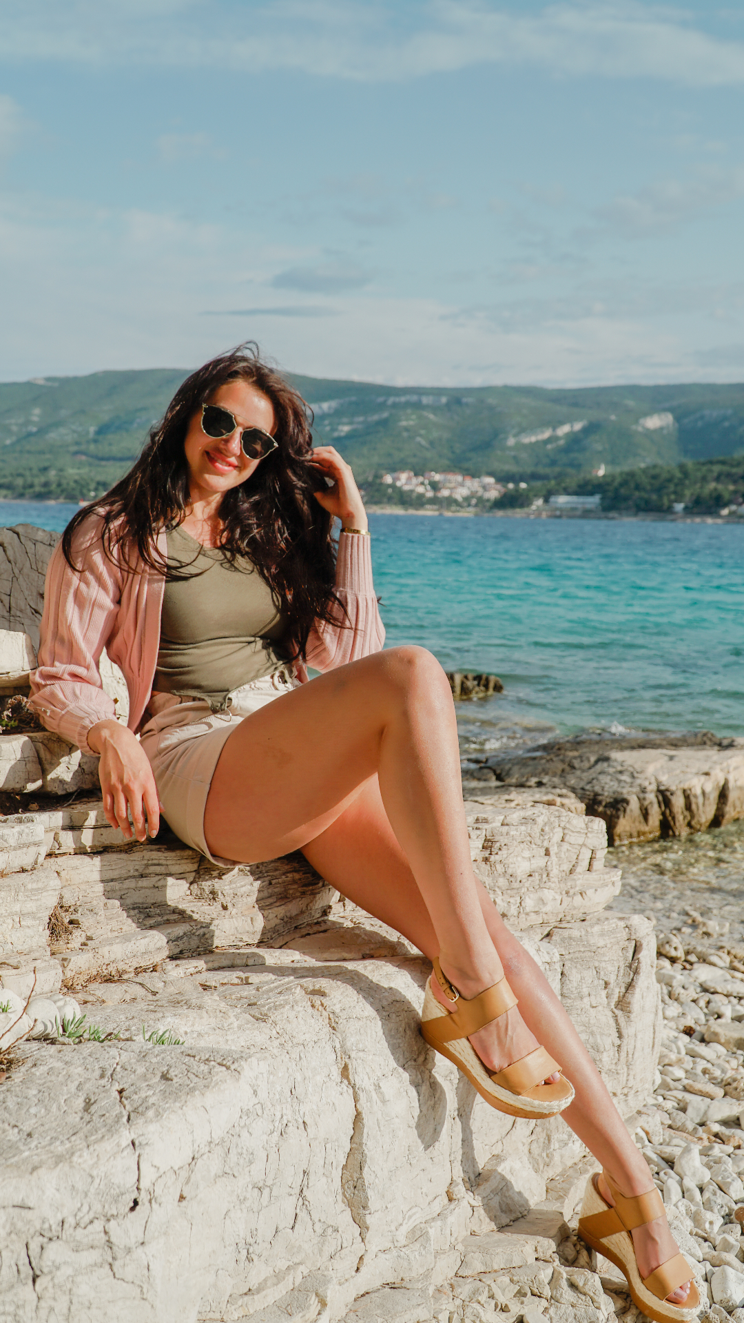 Elegant seaside portrait on stone pier with Croatian coast backdrop